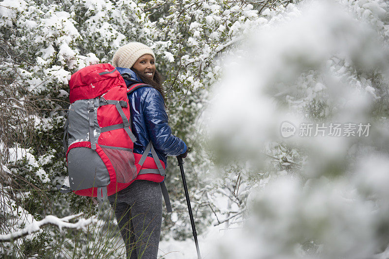 在雪道上徒步旅行的女人。