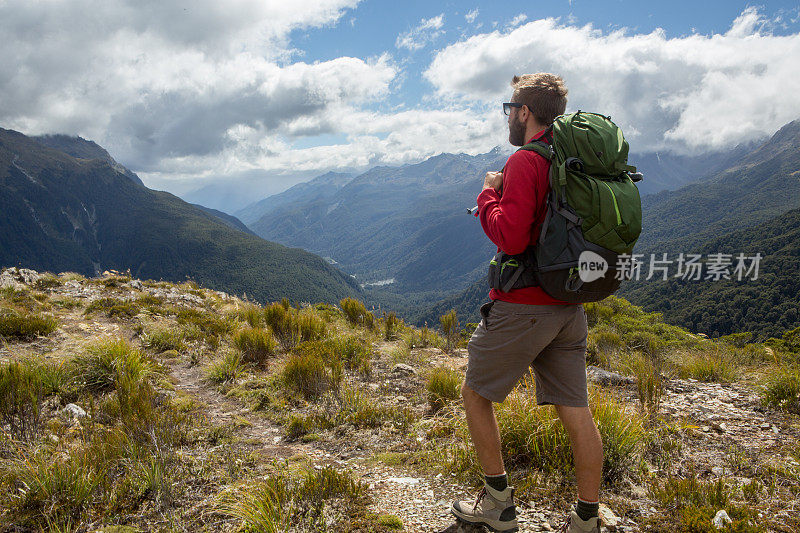 新西兰米尔福德湾，徒步旅行者在山顶欣赏风景