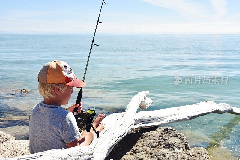 在海边钓鱼的小男孩