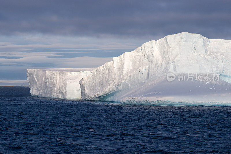 南极洲漂浮的冰山被夕阳照亮
