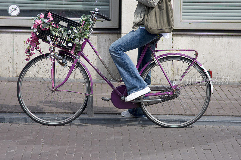 坐在紫色自行车上的女人