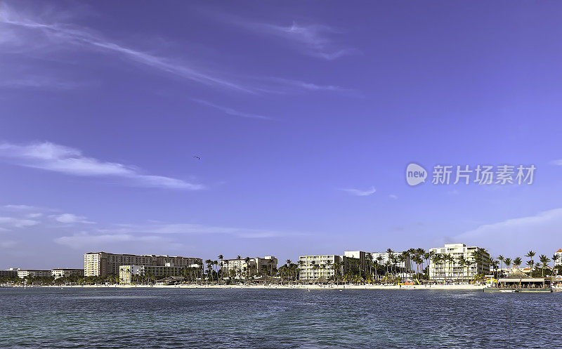 阿鲁巴不断增长的酒店数量和海滨景色，前景是加勒比海
