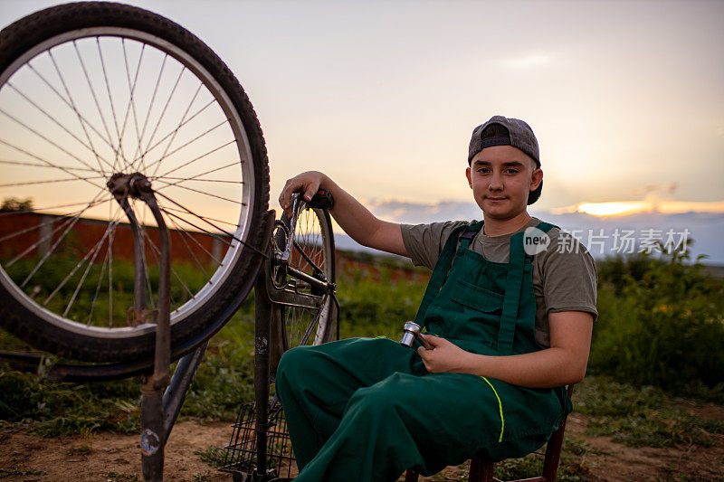 一个自信的少年正在学习修理自行车的手艺