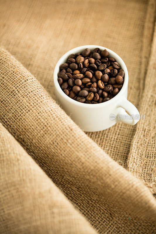 用粗麻袋装在杯子里的咖啡豆