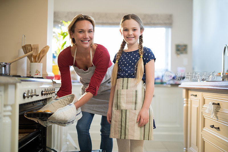母亲和女儿在厨房准备杯形蛋糕