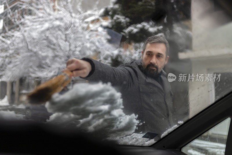 从车上清除雪的人