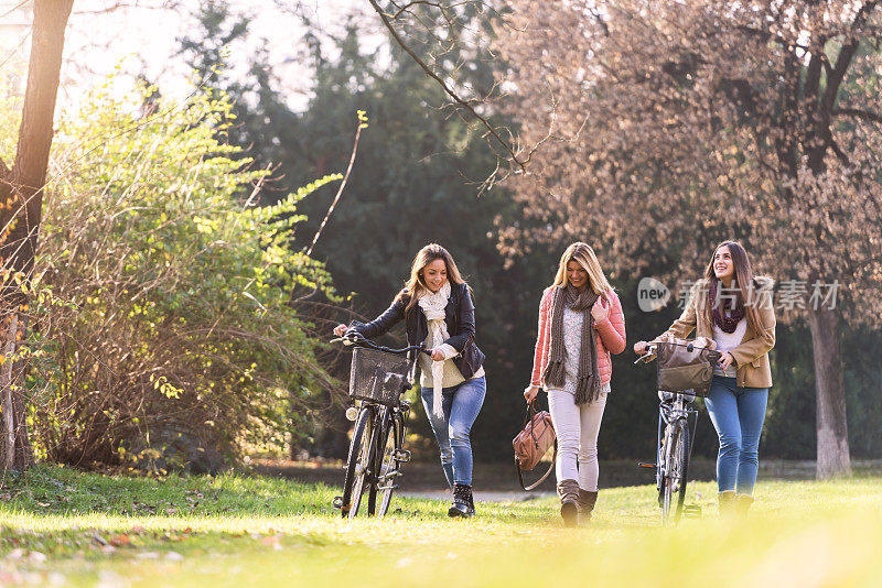 一群微笑的女大学生在公园里散步