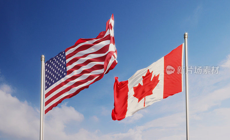 蓝天上飘扬的美国和加拿大国旗