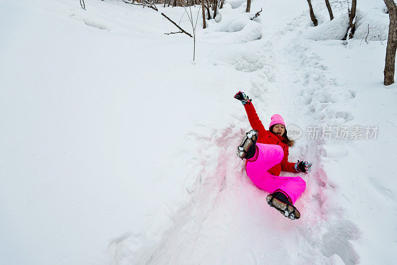 女人摔倒在雪地上