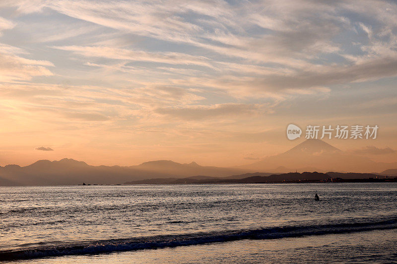 夕阳下，沙滩上的富士山轮廓