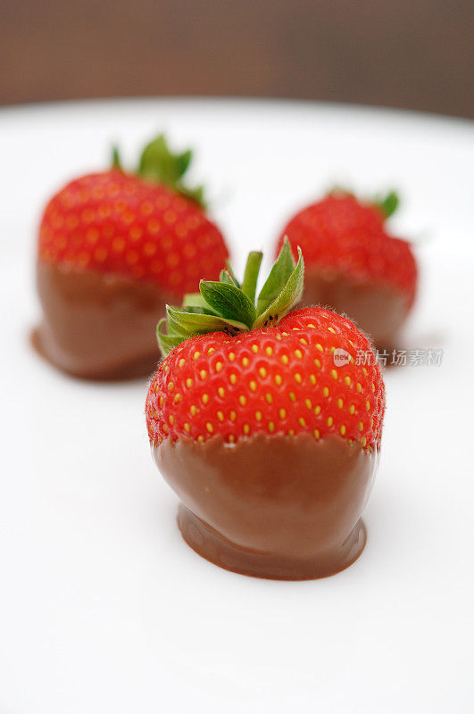 巧克力蘸草莓放在盘子里