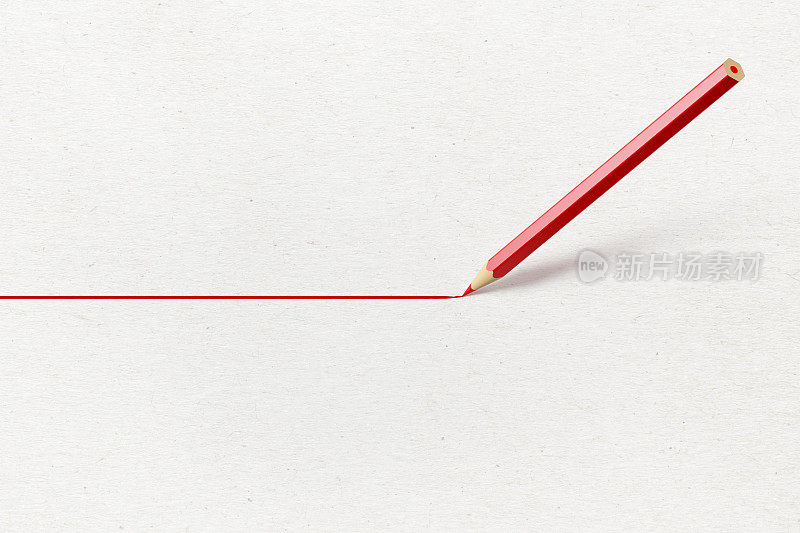 红色铅笔在纸上画一条红色的直线