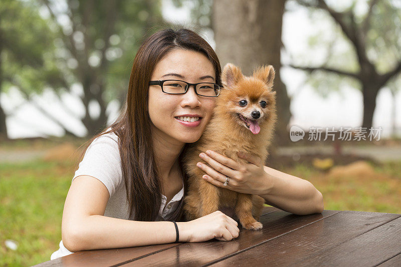 快乐的亚洲女人和博美犬