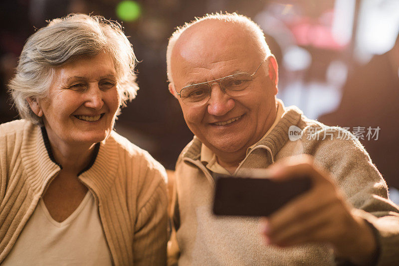 快乐的老夫妻用手机自拍。