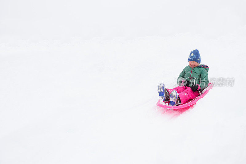 孩子们在暴风雪中快乐地玩雪橇