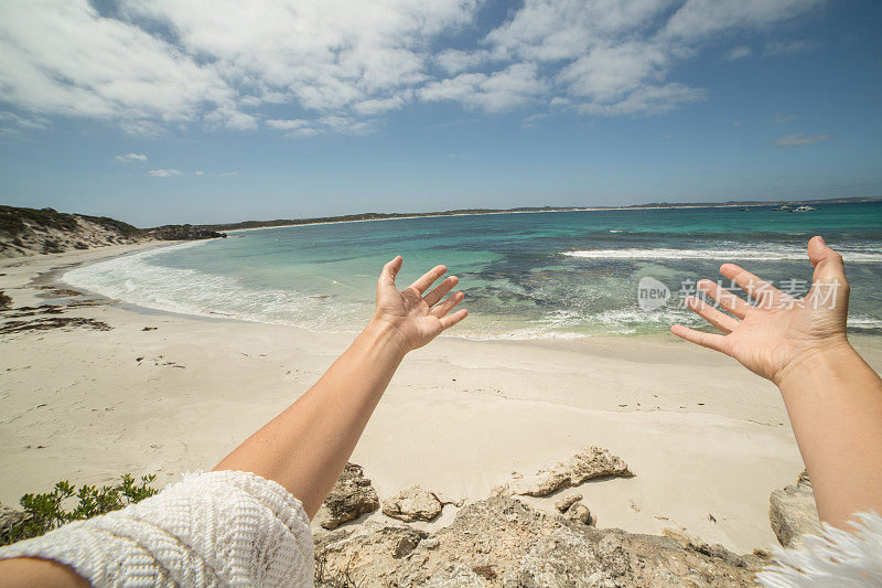 女人的手臂伸向袋鼠岛的一个美丽的海湾