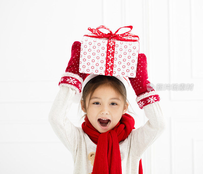 快乐的小女孩展示圣诞礼物