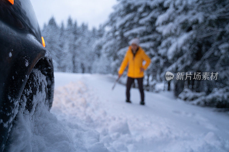 第一场雪后打扫汽车和扫地。紧急照明设备。在恶劣的天气下，汽车会在偏僻的地方抛锚。汽车保险。一个女人在路上。