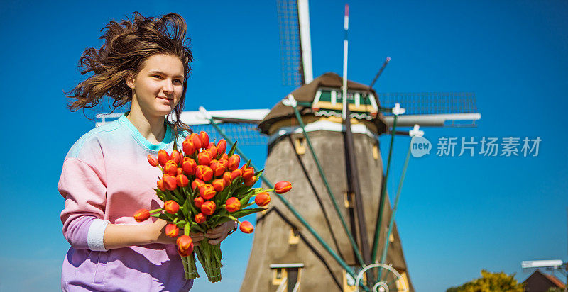 一个荷兰少女在传统的风车里享受自由时光