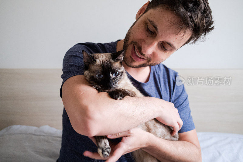 怀里抱着一只猫的男人