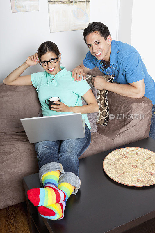 夫妇在家里使用笔记本电脑