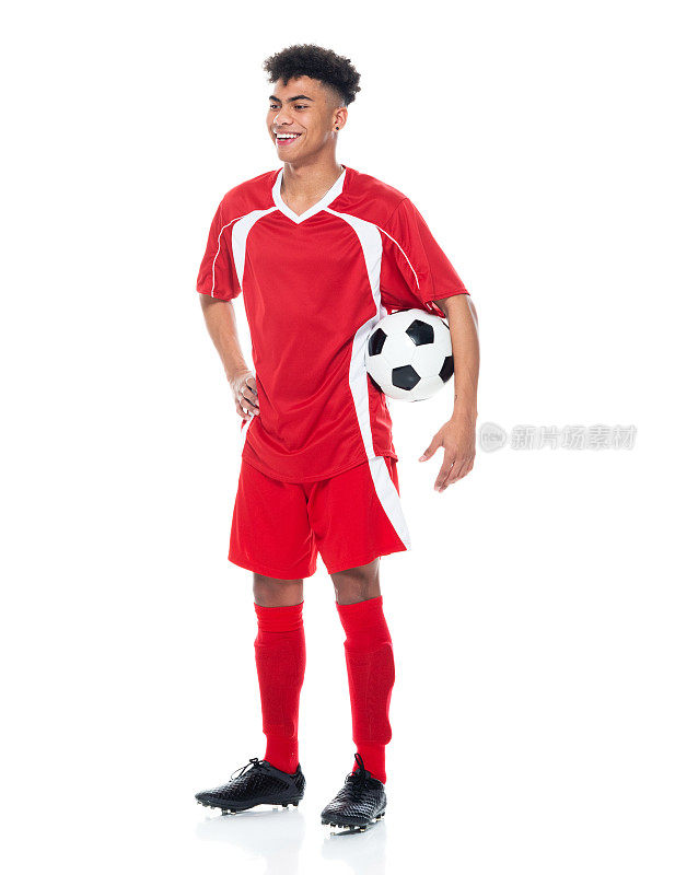 z一代男运动员穿着足球制服站在白色背景前，手持足球进行足球运动和使用运动球
