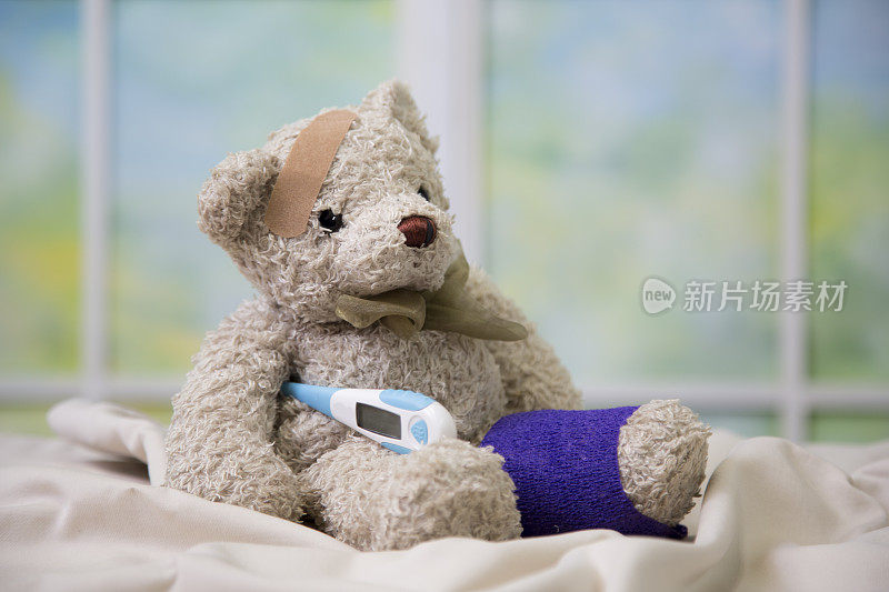 压力时刻——熊宝宝生病了，需要一些TLC。正在给玩具熊宝宝量体温。他的腿上和头上都缠着一条紫色绷带。