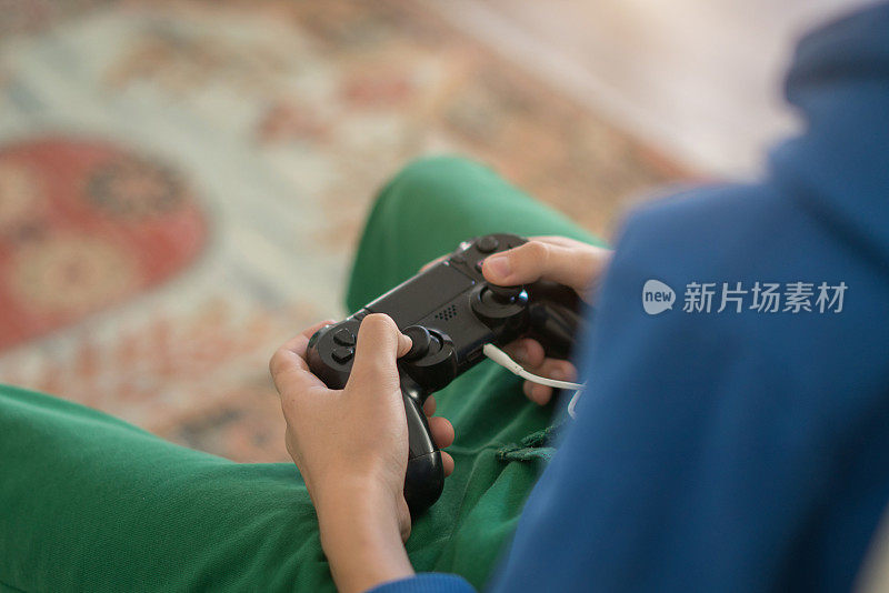 近距离青少年男孩的手沉迷于视频游戏。