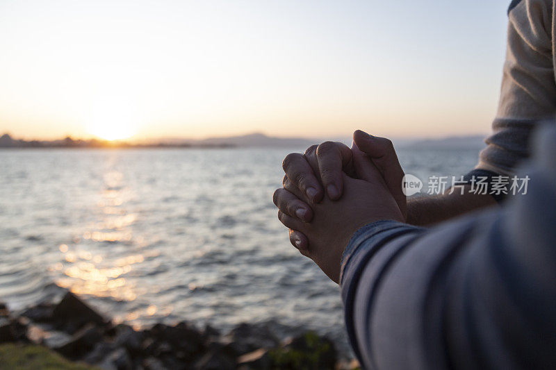 在碧空的海滨，一对情侣手牵着手