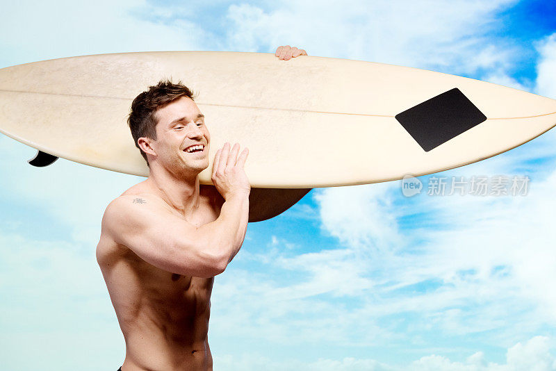 赤裸上身的肌肉男拿着冲浪板