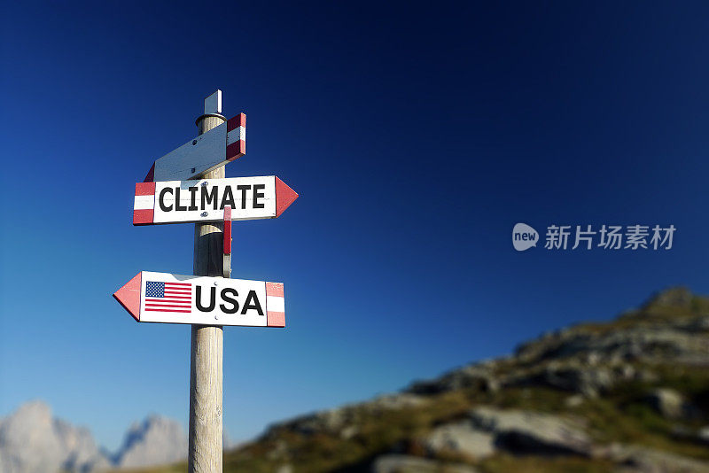 气候变化和美国国旗在两个方向的路标。退出气候协定。