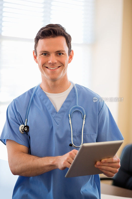 男性医生在诊所使用数字平板电脑