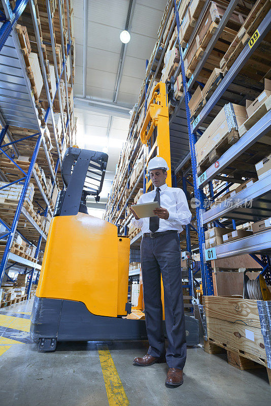 经理站在仓库过道上