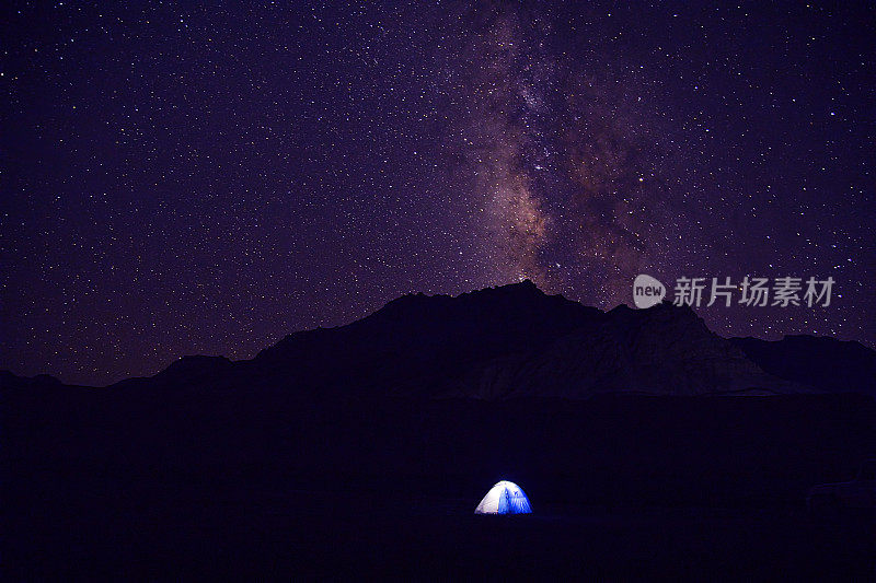 用山和星星照亮帐篷