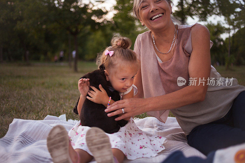 奶奶和孙女喜欢和小狗在一起