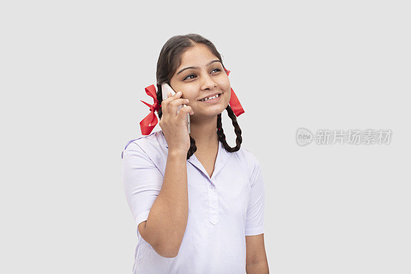 年轻的农村学校女孩在电话里聊天