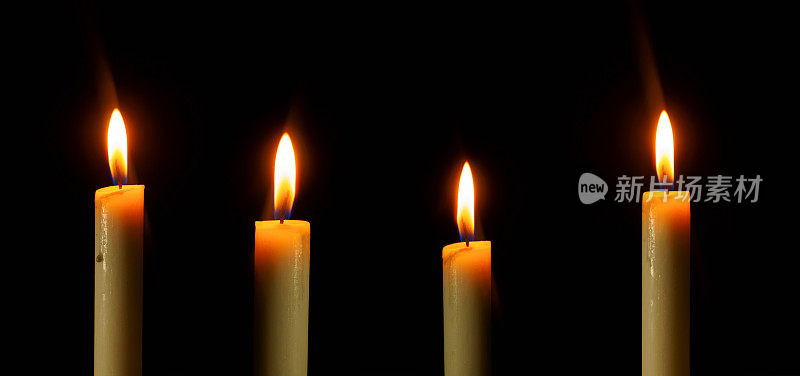 安排不同高度的蜡烛在黑色背景中明亮地燃烧，空白和宽大的背景用于复制空间。