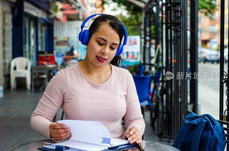 在咖啡店拿着平板电脑学习的女人