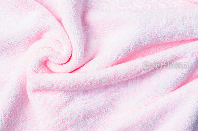 纹理的粉红色天然棉毛巾背景照片与选择性焦点。