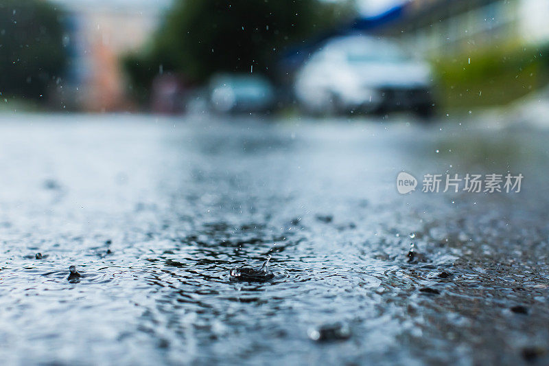 雨滴落在路上。湿沥青。下雨了。天气