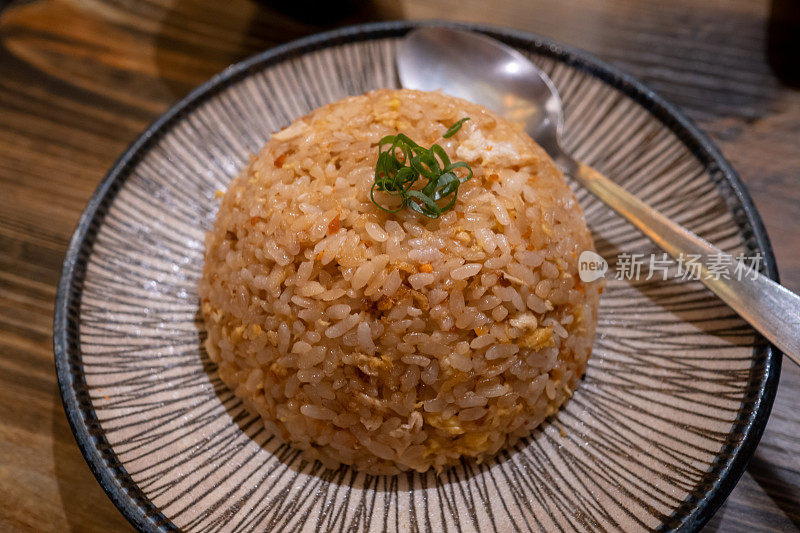 日本炒饭的特写照片被放在一个陶盘上。