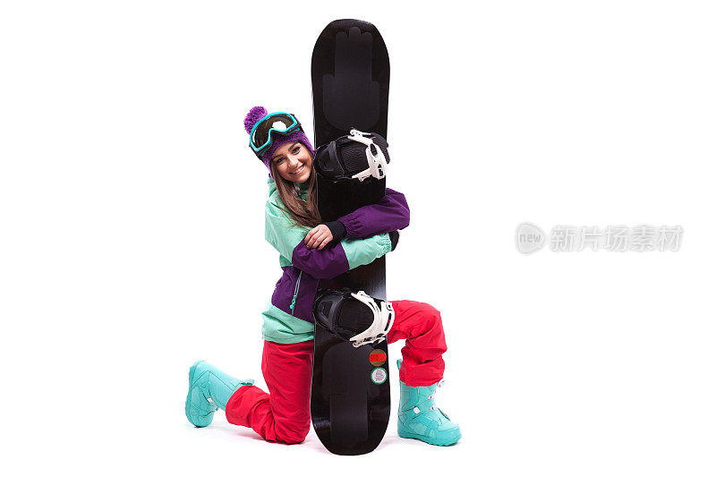 滑雪女子单膝拥抱滑雪板