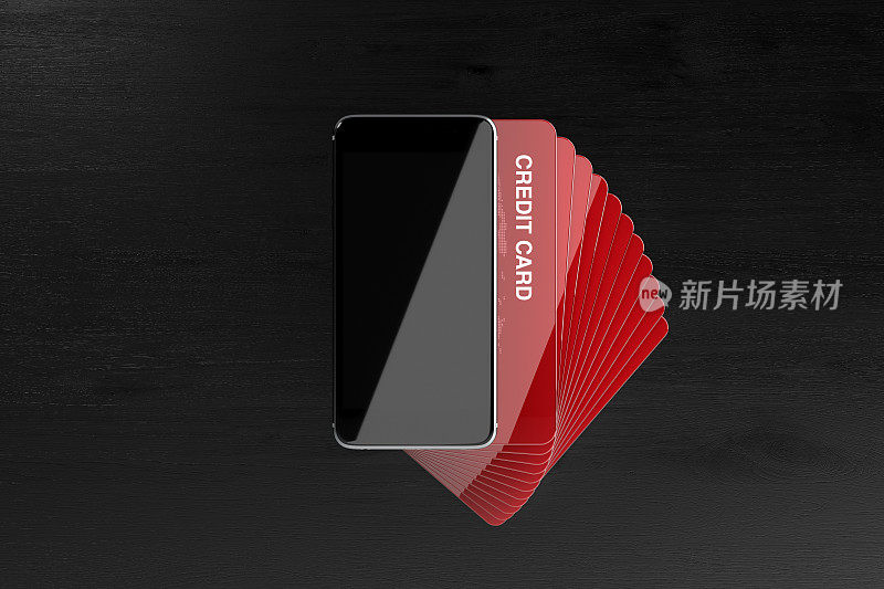 黑色背景下的智能手机和红色信用卡