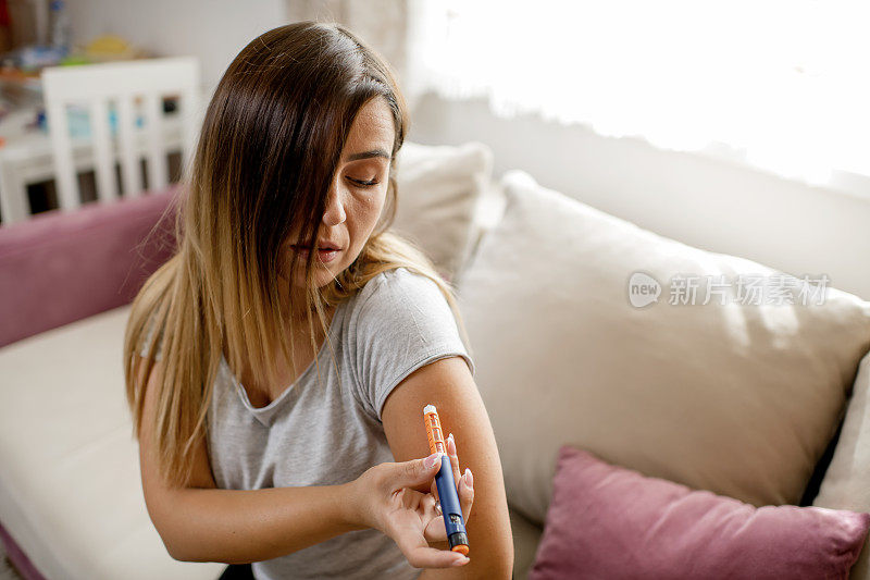 年轻女子在手臂上注射胰岛素