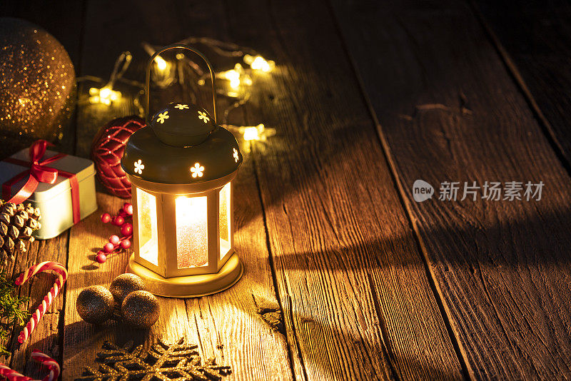 圣诞彩灯、烛光、木头上的礼物和小玩意