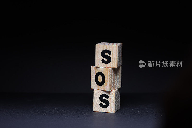 SOS字木制方块在黑色背景