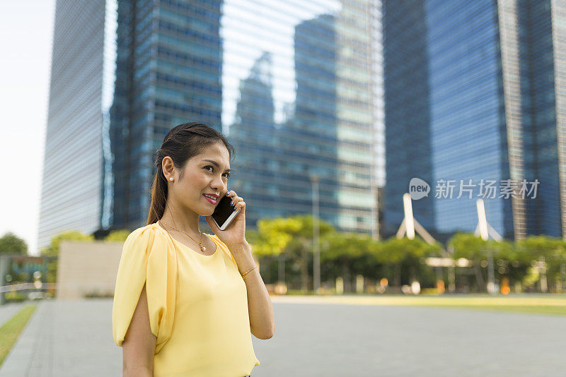 一个亚洲女人在室外打电话