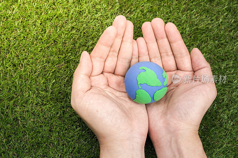 地球，在绿色背景上用粘土制成的泥土。保护绿色地球。地球日节日概念