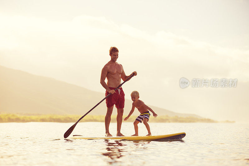 父亲和儿子站起来划桨