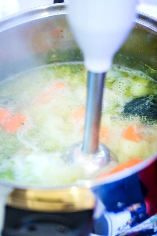 西兰花奶油汤准备，蔬菜用搅拌器切碎，特写